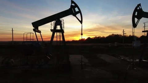 Aerial view of oil pump jack at sunset in Russia. Stock Footage 345393957