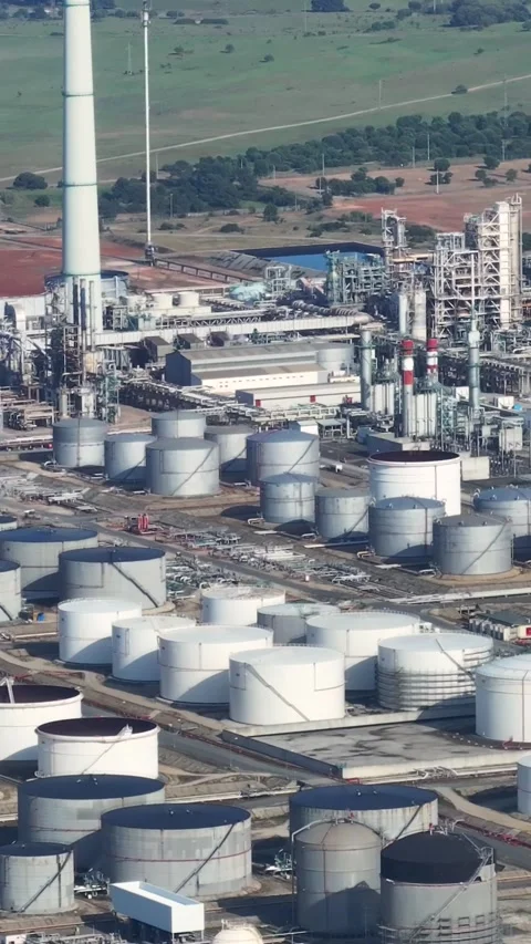 Aerial view of oil refinery complex with fuel storage tanks and processing area Stock Footage 339732643