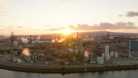 Aerial view of an oil refinery during sunset illuminating industrial activity Stock Footage 330190100