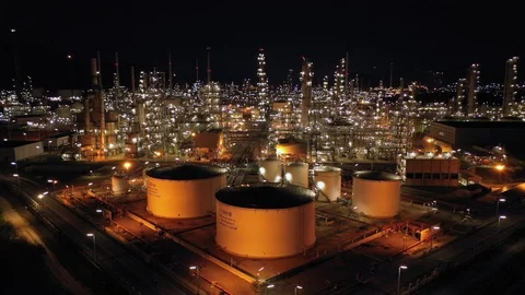 Aerial view. Oil refinery factory and oil storage tank at twilight and night. 4k Stock Footage 108670053