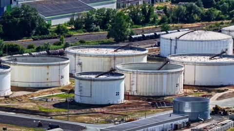 Aerial view of an oil refinery with large storage tanks near the Garonne River Stock Footage 341540004