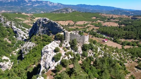 Aerial view of old ancient castle ruins with mountains a Stock Footage 209528081