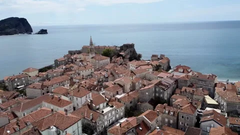 Aerial view of the Old Budva town, port, beach, and mountains. Stock Footage 307153660