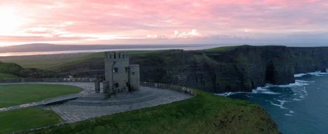 Aerial view of old Castle at the Cliffs of Moher in Ireland. Red sky. Sea and Stock Footage 127924597