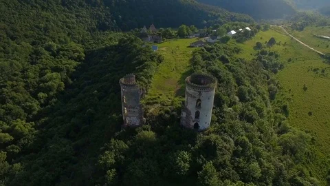 Aerial view of old castle, two towers and forest around Stock Footage 77627302
