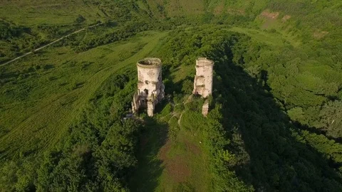 Aerial view of old castle, two towers and forest around Stock Footage 77629139