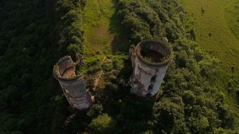 Aerial view of old castle, two towers and forest around Stock Footage 77631139