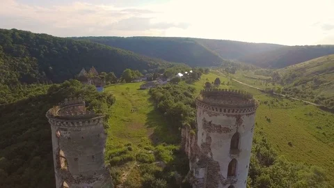 Aerial view of old castle, two towers and forest around Stock Footage 77632046