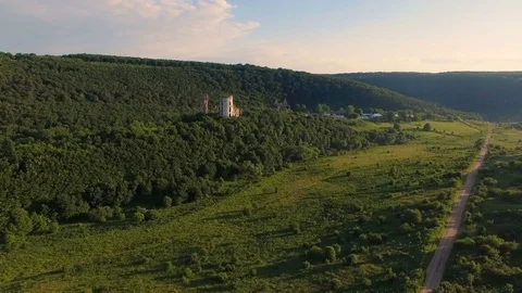 Aerial view of old castle, two towers and forest around Stock Footage 77633694