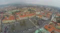 Aerial view of old city, central square, red roofs, gloomy mountains on horizon 4k or 4k+ Resolution