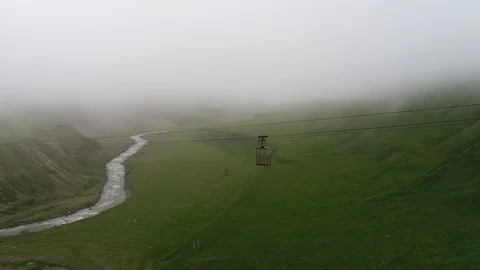 Aerial view of old immobilized cable car over abyss. Stock Footage 91048360