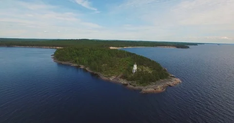 Aerial view old lighthouse on cape among endless lake  Stock Footage 100981781