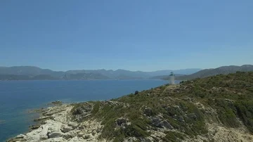 Aerial view of old lighthouse on the cliff of Punta Mortella, Corsica Stock Footage 85556482