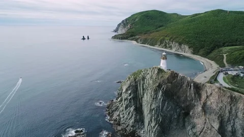 Aerial view of an old lighthouse on the cliff on pacific coast. Beautiful Video stock 168657926