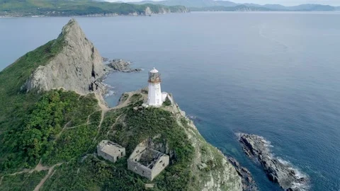 Aerial view of an old lighthouse on the cliff on pacific coast. Beautiful Video stock 168659580