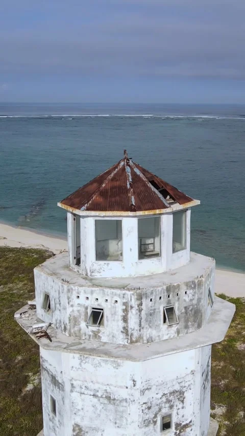 Aerial view of old lighthouse at ocean coastline.Vertical video Stock Footage 300431285