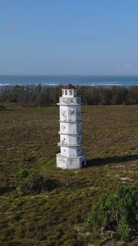 Aerial view of old lighthouse at ocean coastline.Vertical video Stock Footage 300431287