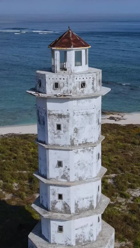 Aerial view of old lighthouse at ocean coastline.Vertical video Stock Footage 300431295