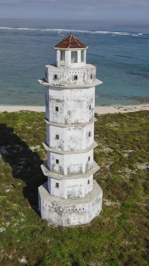 Aerial view of old lighthouse at ocean coastline.Vertical video Stock Footage 300431300