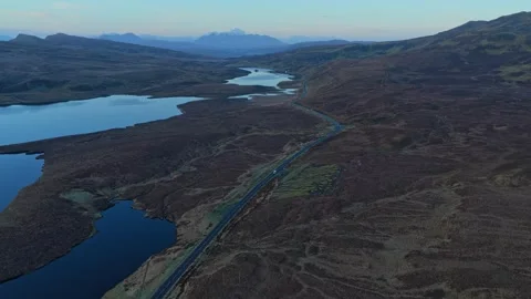 Aerial view of old man of storr with car driving on a country road 库存影片 334059752