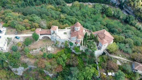 Aerial view of old monastery hiding in the forests, also known as Motsameta Stock Footage 106219696