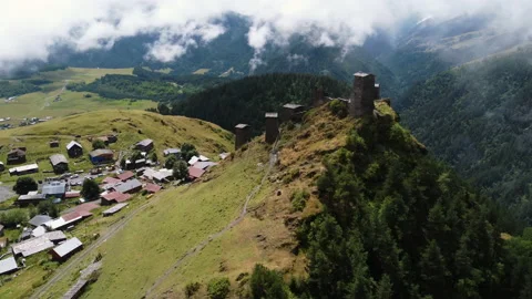 Aerial view of old monastery ruins in th hill with rural village below Stock Footage 229880997