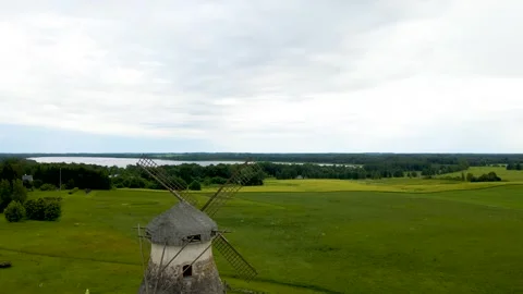 Aerial view of an Old Stone Windmill Standing in a Green Countryside Landscape Stock Footage 334699738