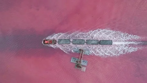 Aerial view of an old train rides on the railway laid in the water through the Stock Footage 231602338