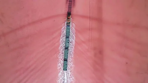 Aerial view of an old train rides on the railway laid in the water through the Stock Footage 231602532