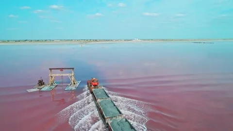 Aerial view of an old train rides on the railway laid in the water through the Stock Footage 231602594
