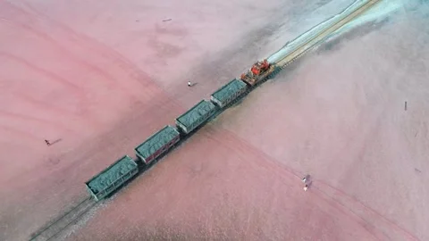 Aerial view of an old train rides on the railway laid in the water through the Stock Footage 250454860