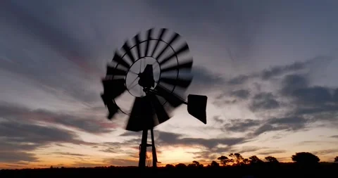 Aerial view of Old Windmill Spinning at Sunset Video stock 227263264