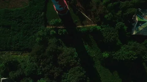 Aerial view of the old working lighthouse among the green grass and trees Stock-Footage 87668211