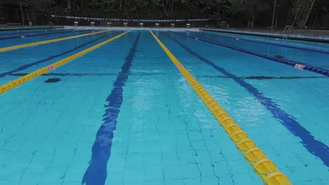 Aerial view of Olympic lap pool in Bali with yellow lane divider symmetry Stock Footage 326579291