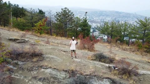 Aerial view. One guy with a beard is on the mountain. Stock Footage 218219112