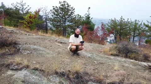Aerial view. One guy with a beard is on the mountain. Stock Footage 218219138