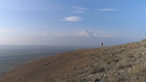 Aerial view: one man walking on the fog mountain Stock Footage 82973789
