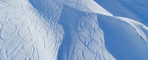 Aerial view of One skier going downhill off-piste in the Swiss Alps.  Stock Footage 121477908