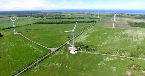 Aerial view at onshore wind farm with group of horizontal axis wind turbines Stock Footage 77108248