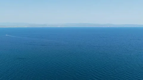 Aerial view of the open blue sea near Diaporos island, with distant coastline Stock Footage 346680391