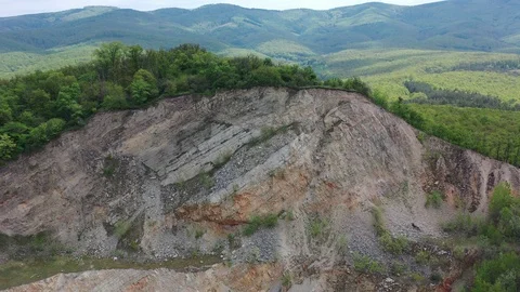Aerial view of open-cast quarry mine revealing dirty pond at bottom, 4K Stock Footage 107888135