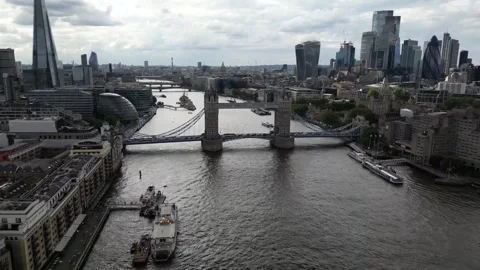 Aerial view of the open lifted Tower Bridge of London, England, a cloudy day Stock Footage 314571471