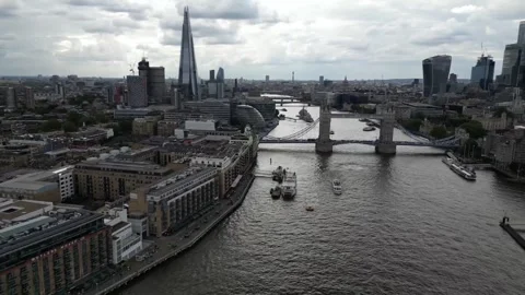 Aerial view of the open lifted Tower Bridge of London, England, a cloudy day Stock Footage 314571480
