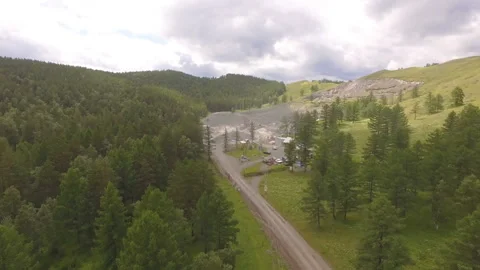 AERIAL: A view of the open pit for the extraction of gravel among the mountains. Stock Footage 87109865