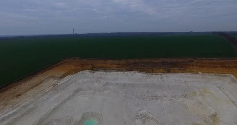 Aerial view of open pit kaolin clay mine with turquoise pool of water Stock Footage 127444196
