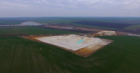 Aerial view of open pit kaolin clay mine with turquoise pool of water Video stock 128500721