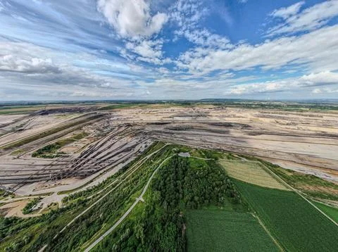 Aerial View of Open Pit Mine Beside Green Farmland Stock Photos