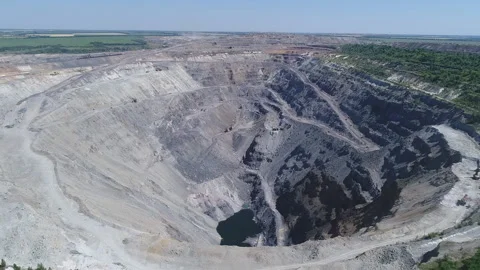 Aerial view of opencast mining quarry with lots of machinery at work - view from Stock Footage 103198414
