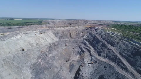 Aerial view of opencast mining quarry with lots of machinery at work - view from Stockbeeldmateriaal 103248375
