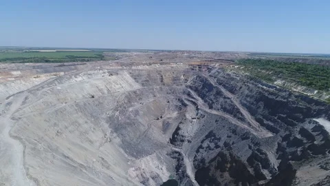 Aerial view of opencast mining quarry with lots of machinery at work - view from Stockbeeldmateriaal 103249135